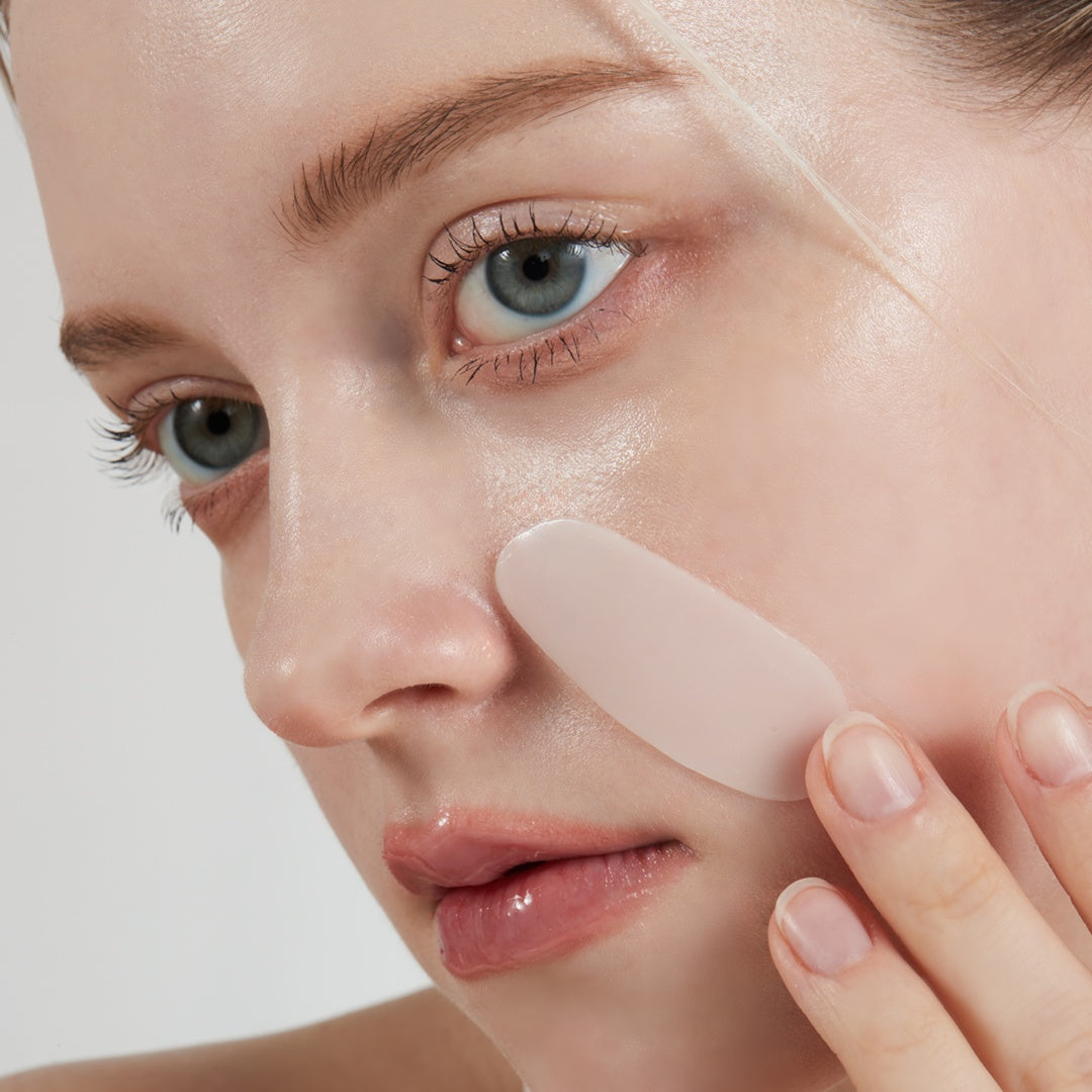 Woman applying a hydrogel collagen patch from VINNE Bio Deep Collagen Mask for targeted overnight skincare