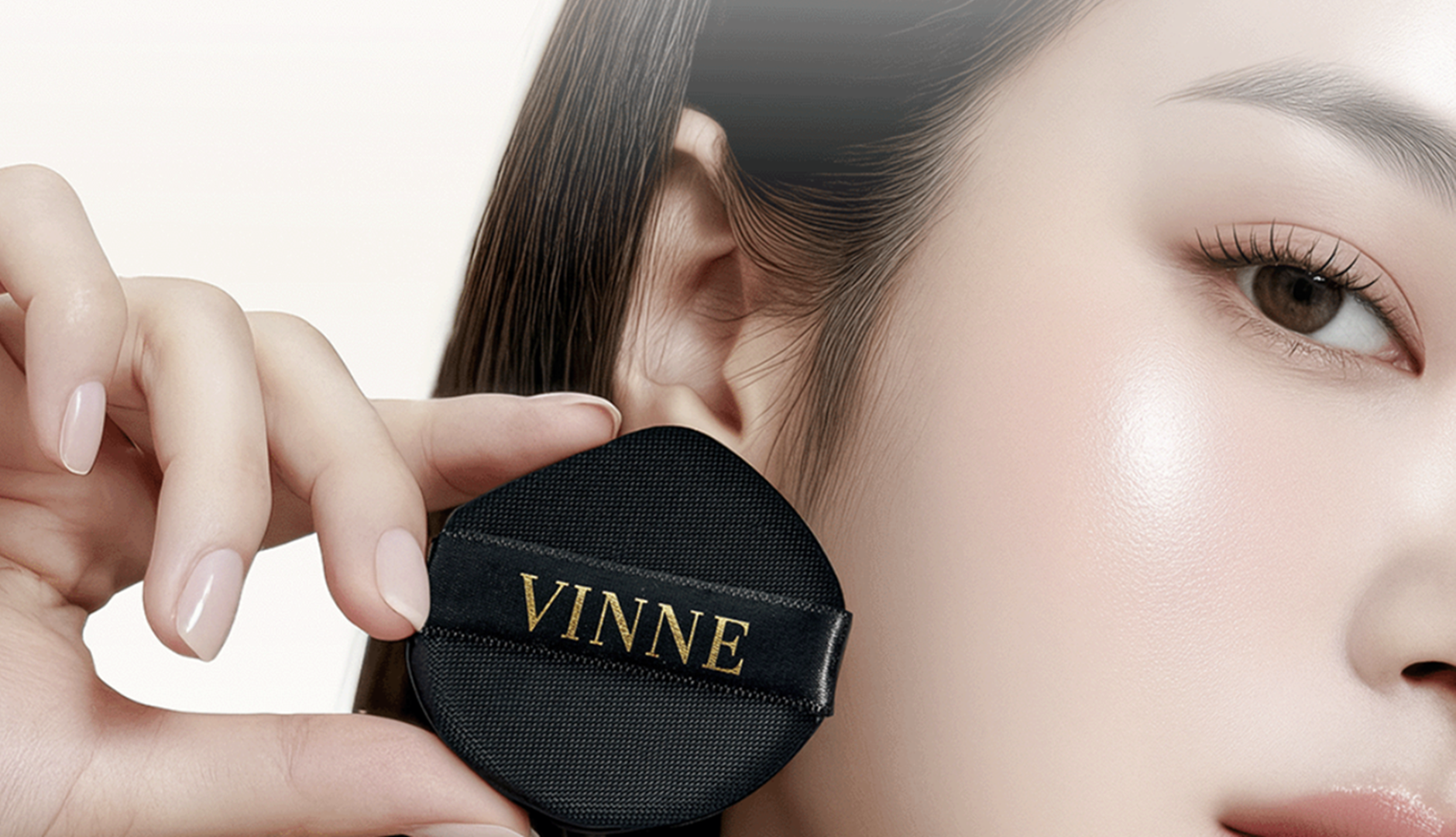 Person wearing a black earbud with 'VINNE' branding, close-up of ear and face.