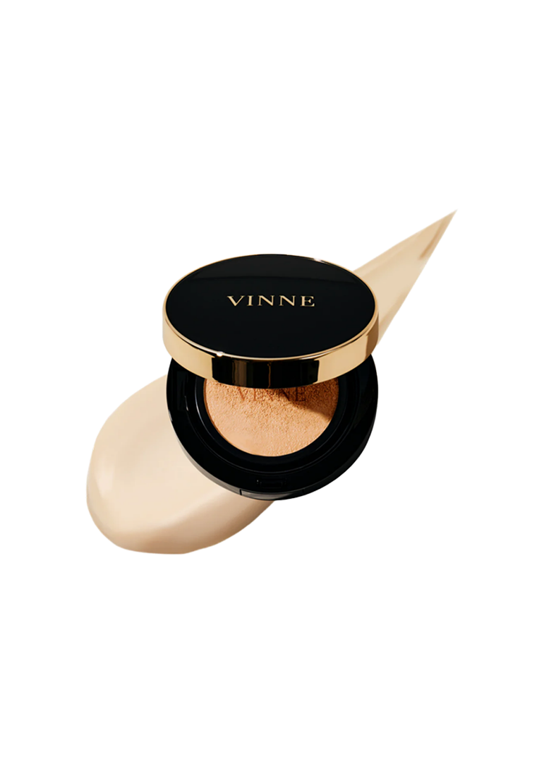 A compact cushion foundation by VINNE with a sponge applicator, in a natural beige shade, housed in a black and gold case. VINNE Cushion Foundation #23 Natural Beige for flawless glass skin finish