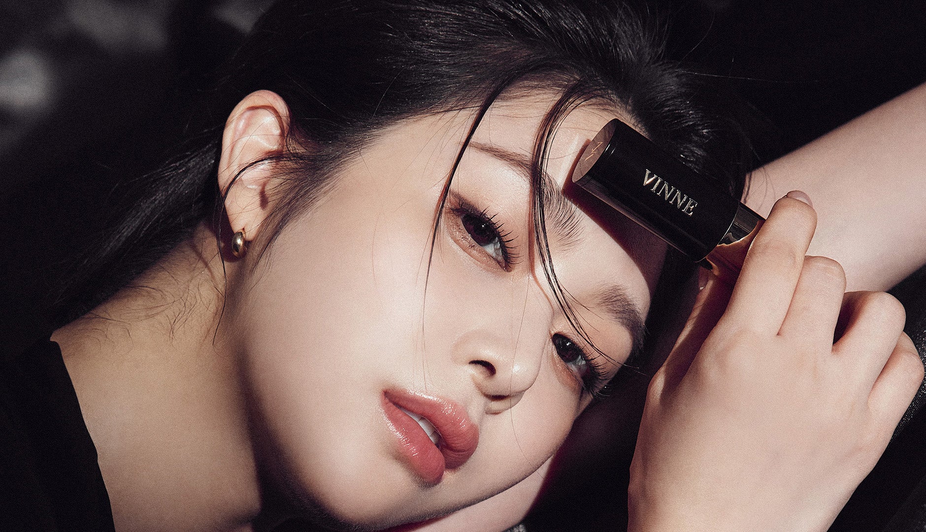Close-up of a person holding a makeup product with VINNE Hair Cushion
